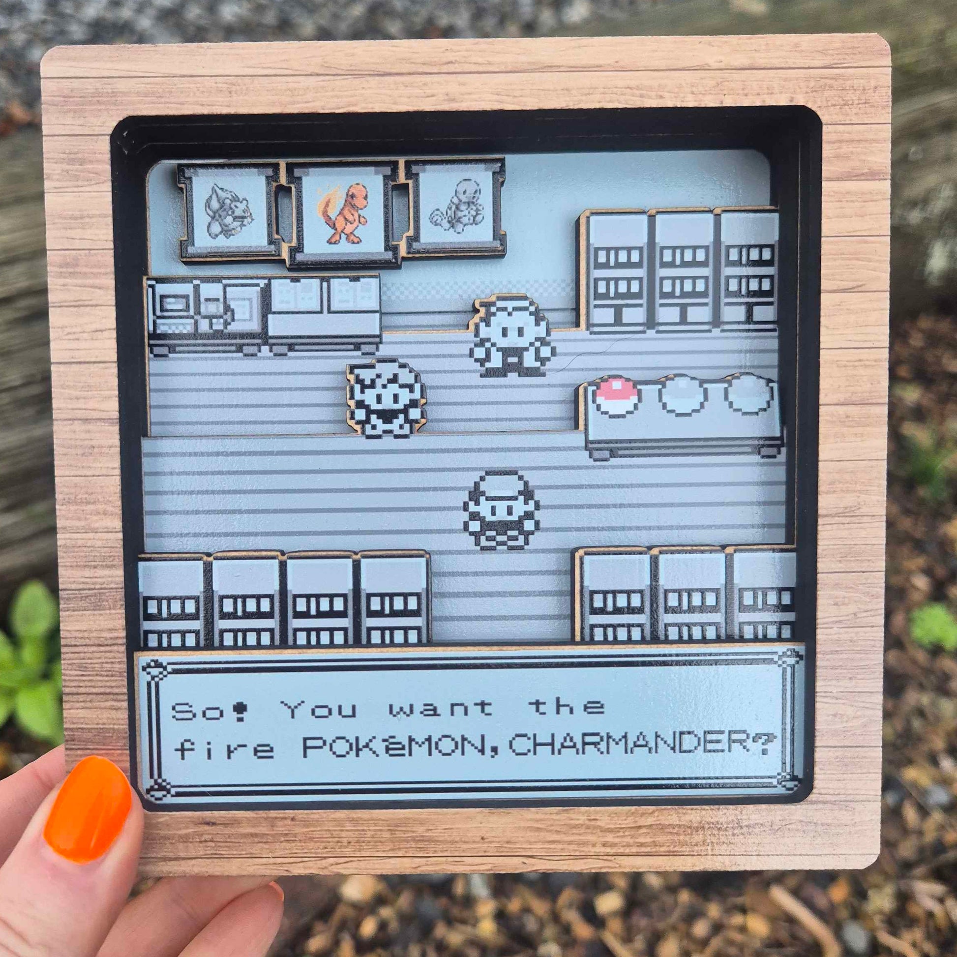 Small screen displaying a pixelated game interface held by a hand outdoors.