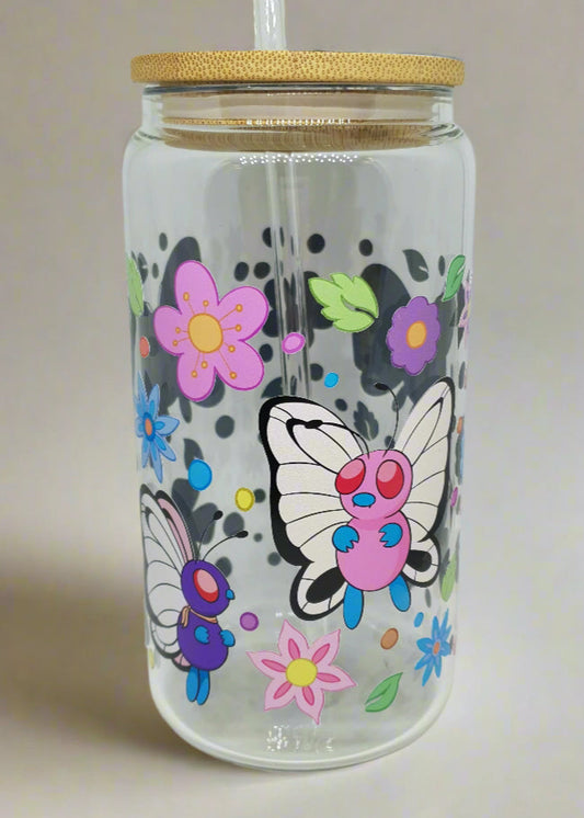 Clear tumbler with colorful butterfly and flower designs on a white background