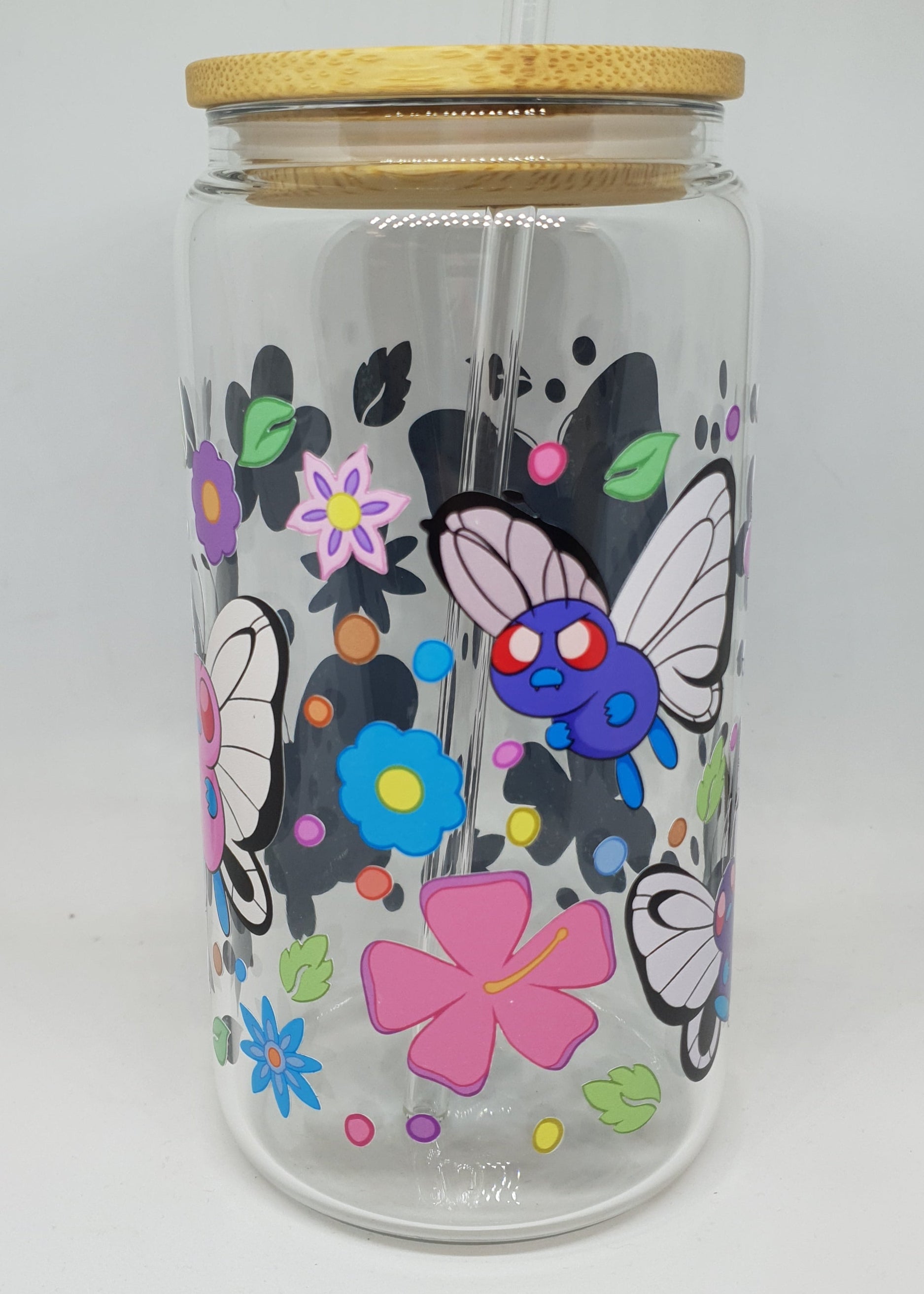 Glass jar with colorful butterfly and flower design on a white background