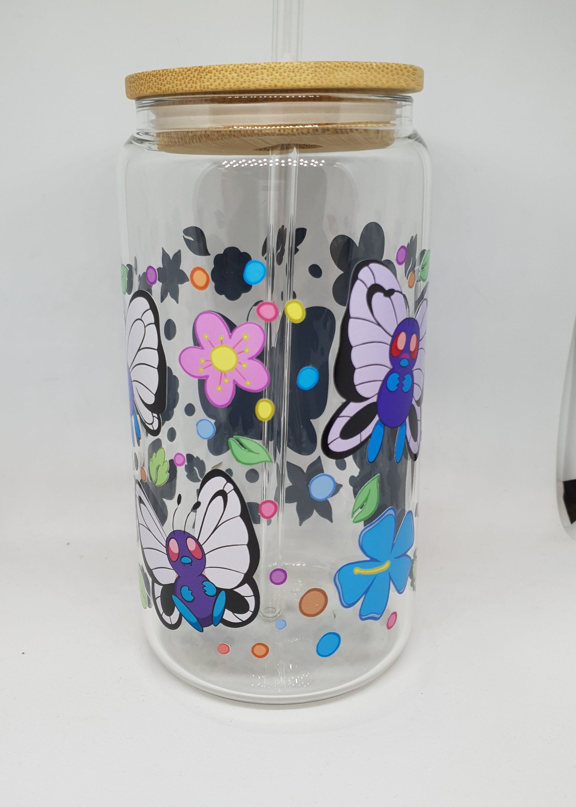 Clear glass jar with floral designs and a wooden lid