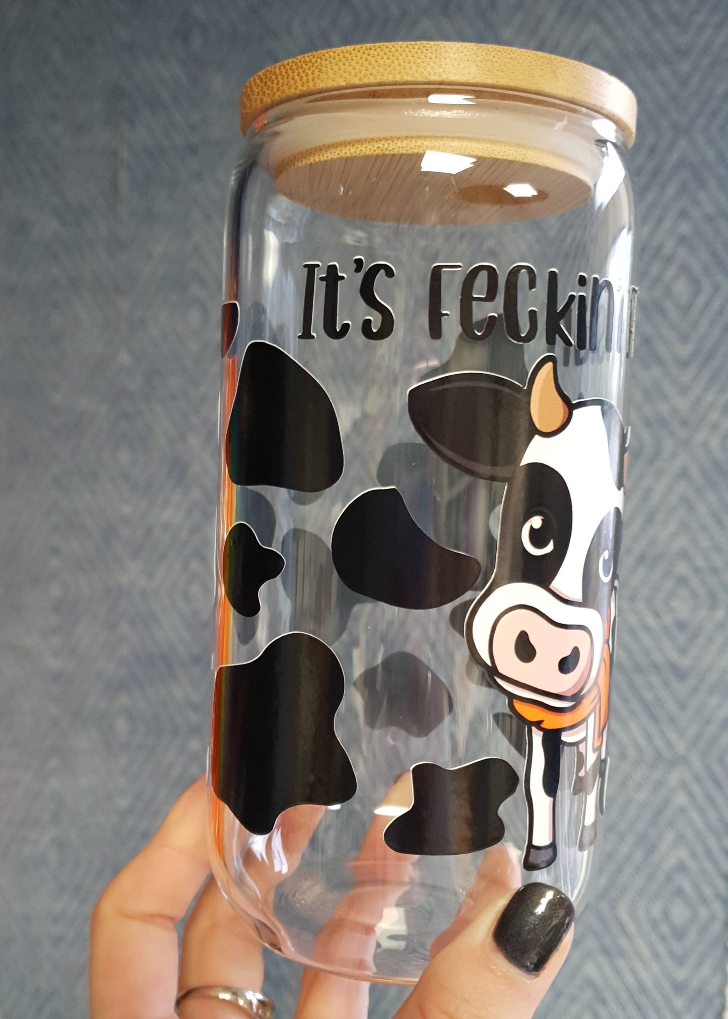 Clear tumbler with cow print and 'it's feckin friesian' text