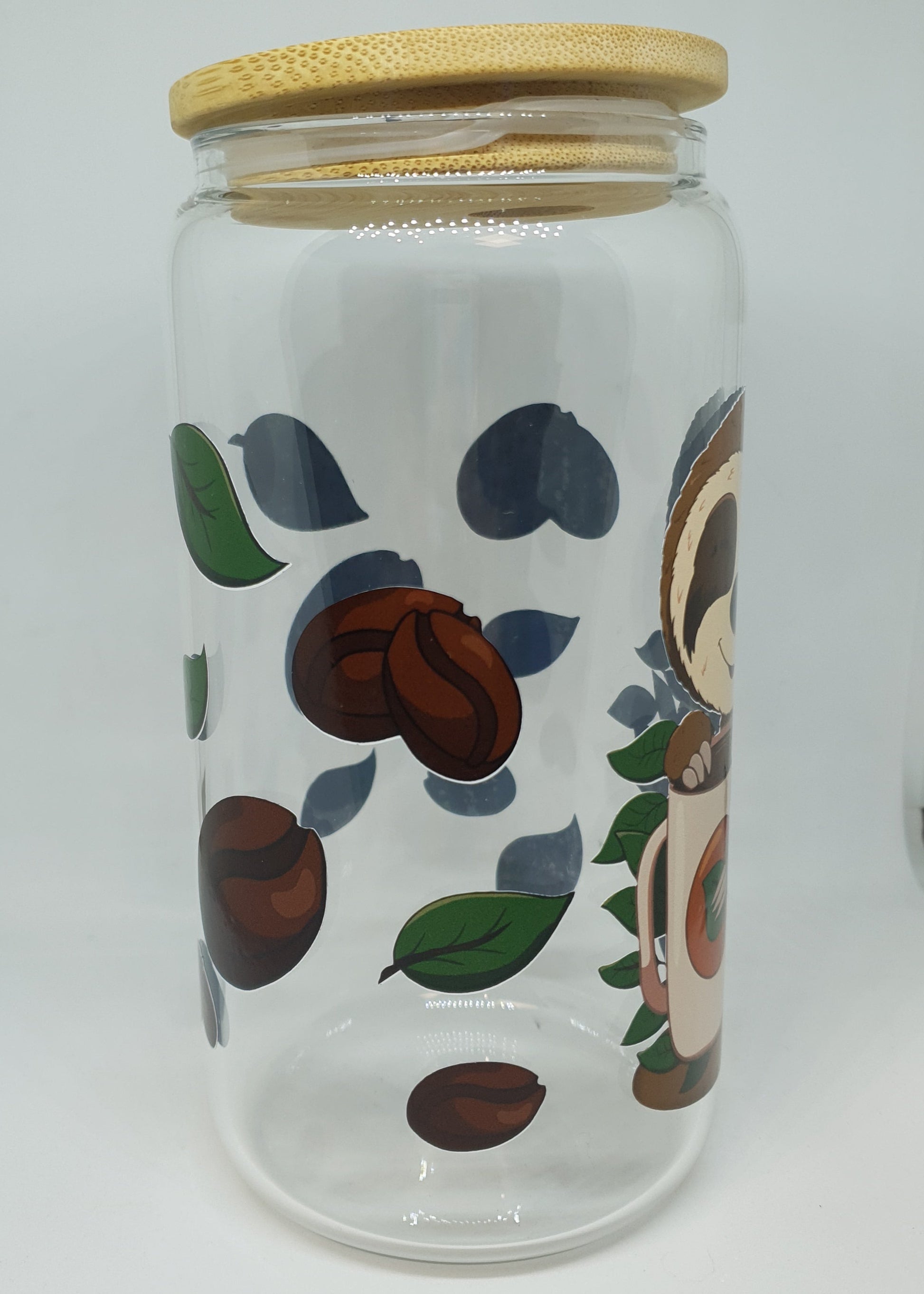 Glass jar with coffee bean design and wooden lid on a white background